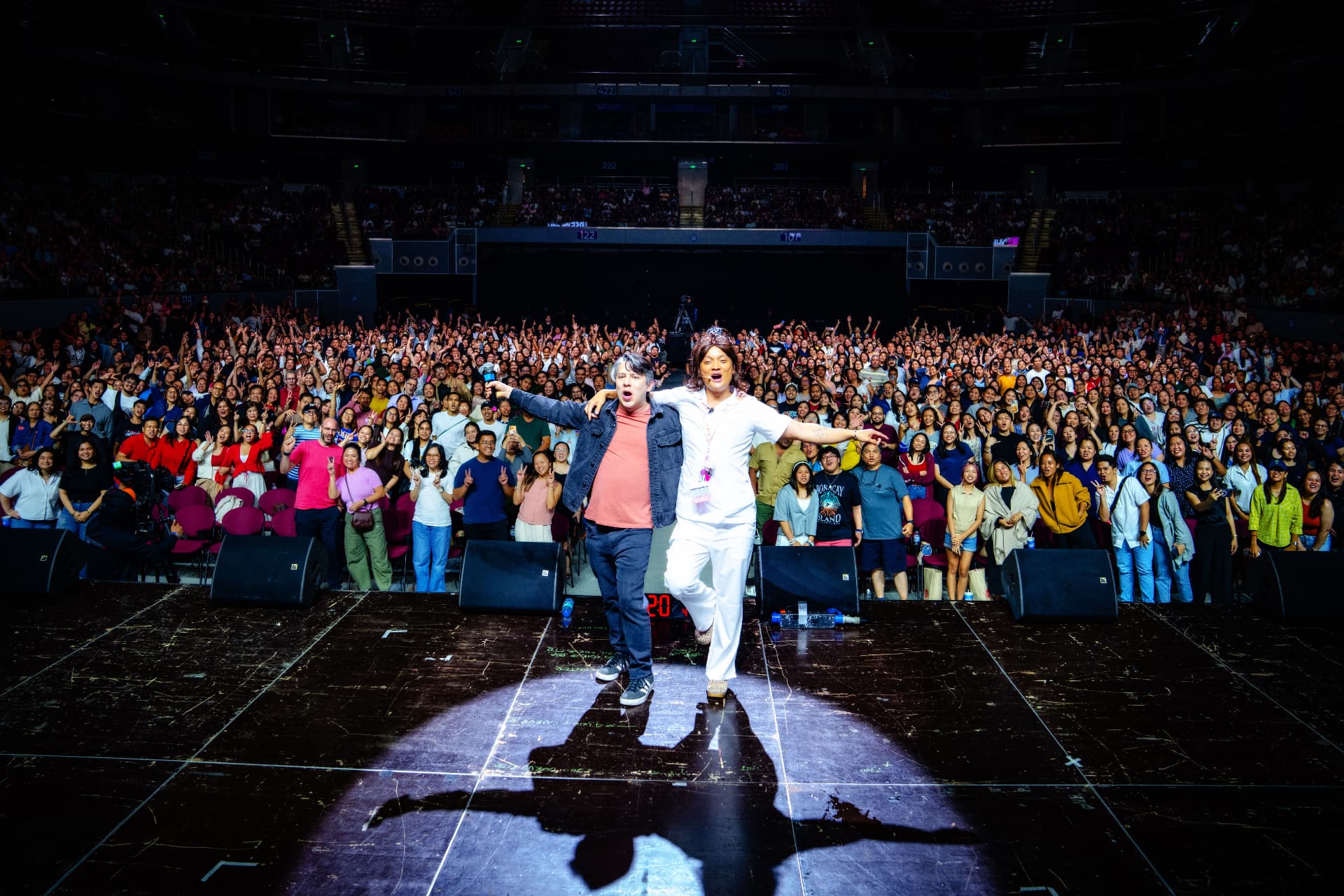 Nurse John on stage at a packed arena